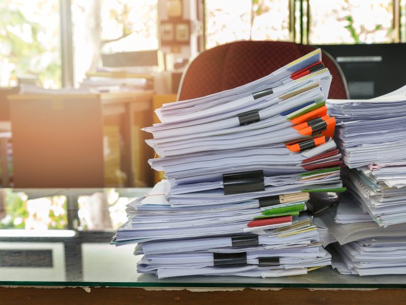 Close up of business documents stack on desk , report papers stack